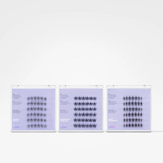 Three slim rectangular product boxes with white borders and pale lavender fronts are arranged side by side on a clean white background. Each box contains many small black-and-white illustrated figures or symbols arranged in rows.