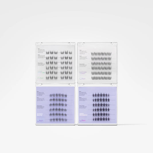 Four clear plastic trays containing multiple rows of black eyelash extensions, arranged in a 2x2 grid on a light gray background.