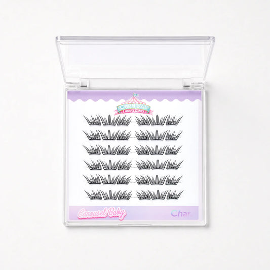 A package of false eyelashes in a clear plastic case with a white insert. The insert shows 12 pairs of black false eyelashes arranged in two columns, with a lavender header and footer.