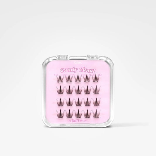 A clear plastic case containing false eyelashes on a light pink card labeled 'Candy Cloud' and 'The Luvy Baggage', shown on a clean white background.