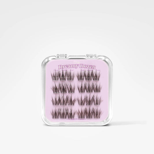A pack of 12 false eyelash clusters in a clear plastic case with a light pink insert card labeled 'Dreamy Dozen'.