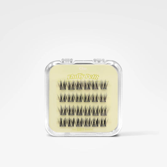 A small clear plastic case containing multiple pairs of black false eyelashes on a pale yellow insert, photographed on a clean white background. The insert shows the brand name 'Blinky Pets'.