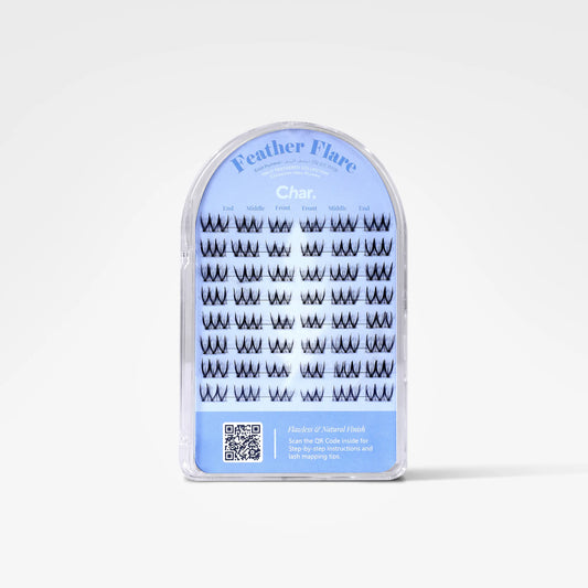 A package of Feather Flare false eyelashes in the shade Charcoal, shown in a clear plastic arch-shaped case with a light blue label.