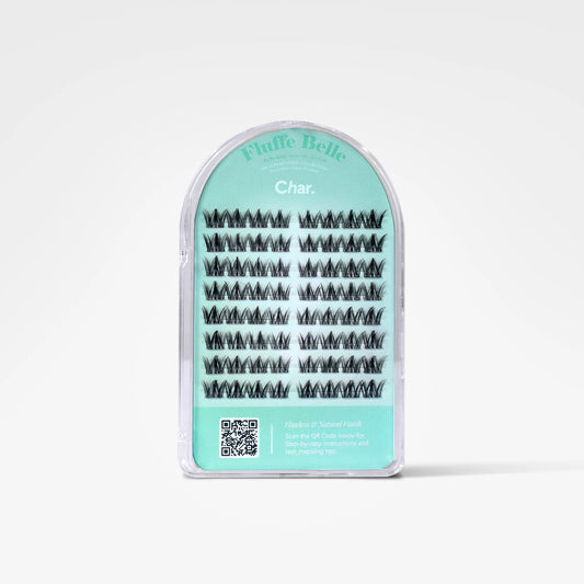 A package of Fluff Belle false eyelashes in the shade Char., shown in a clear arched plastic case with a mint green label on a white background.