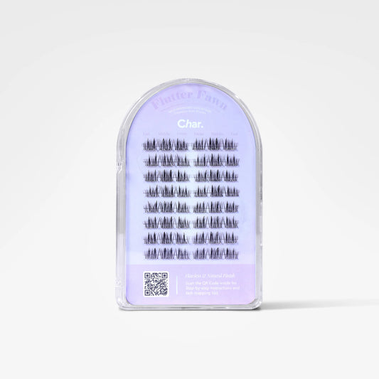 A package of false eyelashes in a clear plastic arch-shaped case with a light lavender label. The label reads 'Fluffer Fans' and 'Char.