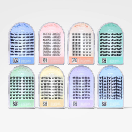 Eight packages of false eyelashes arranged in two rows on a plain white background. Each package has a different pastel color: blue, pink, peach, mint green, light green, lavender, and dark blue, with labels including Feather Flake, Dreamy Waves, Velvet Silk, and Cloud Silk.