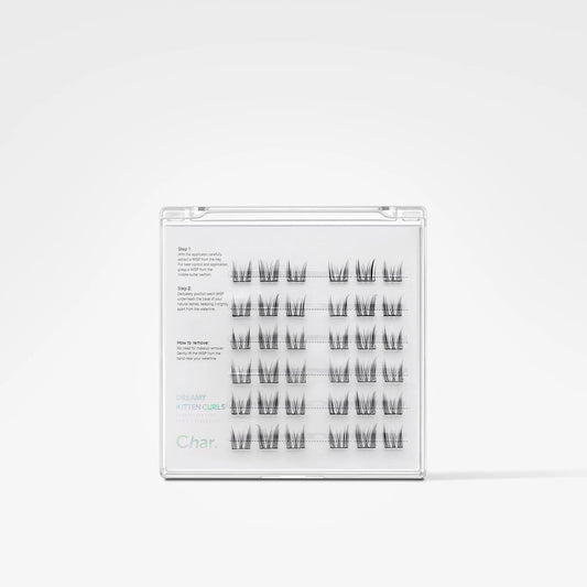 A clear plastic clamshell package containing multiple pairs of black false eyelashes arranged in rows on a white insert, photographed against a clean white background.