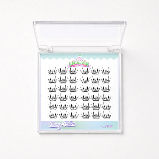 A clear plastic clamshell case containing rows of black false eyelash clusters on a white backing card. The card has pastel blue and pink decorative borders and visible text including 'Starry Glitter' and 'Char'.