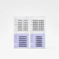 Four clear plastic trays containing multiple rows of black eyelash extensions, arranged in a 2x2 grid on a light gray background.