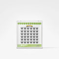 A package of false eyelashes on a white background. The lashes are arranged in a grid inside a clear plastic case with a green and white label.