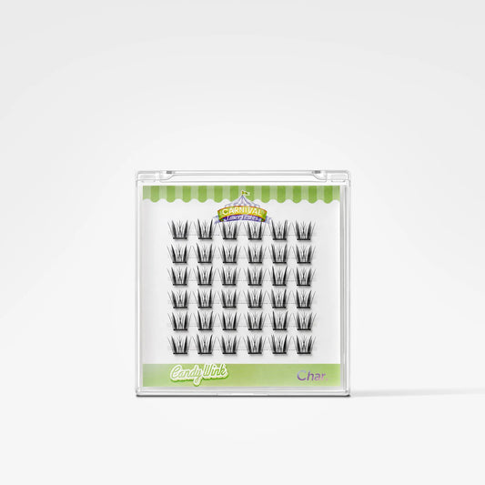 A package of false eyelashes on a white background. The lashes are arranged in a grid inside a clear plastic case with a green and white label.