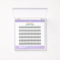 A clear plastic clamshell case containing multiple rows of black false eyelashes on a white insert card with a lavender border. The card shows the brand name 'Cotton Cloud' and a small carnival-themed logo.