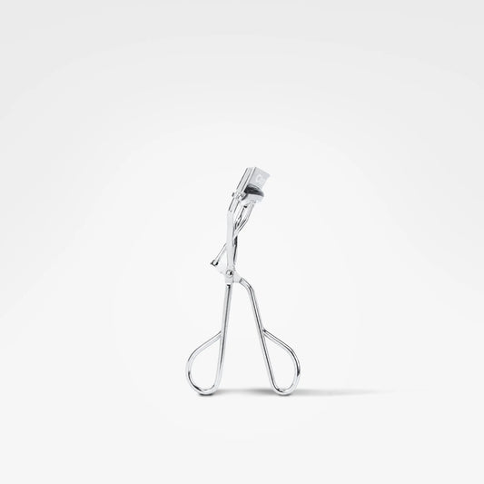 A silver metal eyelash clamp shown from the side against a clean white background.