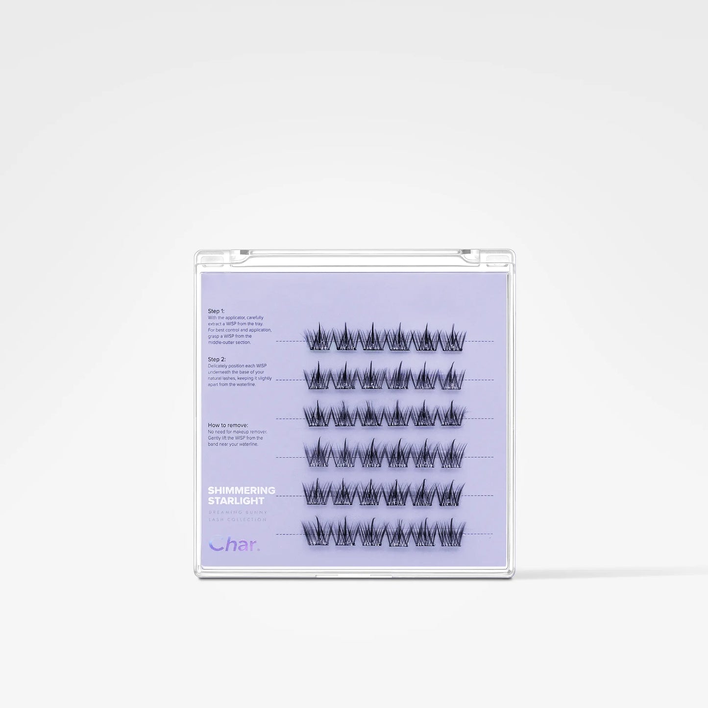 A clear plastic case containing false eyelash clusters on a light lavender insert card, photographed against a clean white background.