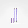 Two lavender purple eyebrow pomade tubes with their caps removed, standing upright on a clean white background.