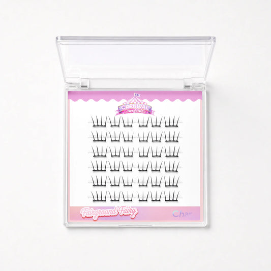 A clear plastic clamshell case containing 20 pairs of black false eyelashes on a white card with pink decorative borders and the brand name 'Fairyground Fairy' visible.