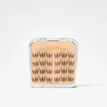 A clear plastic clamshell case containing 18 pairs of false eyelashes on a beige card labeled 'Daring Macaron' by The Bitter Batch, set against a clean white background.