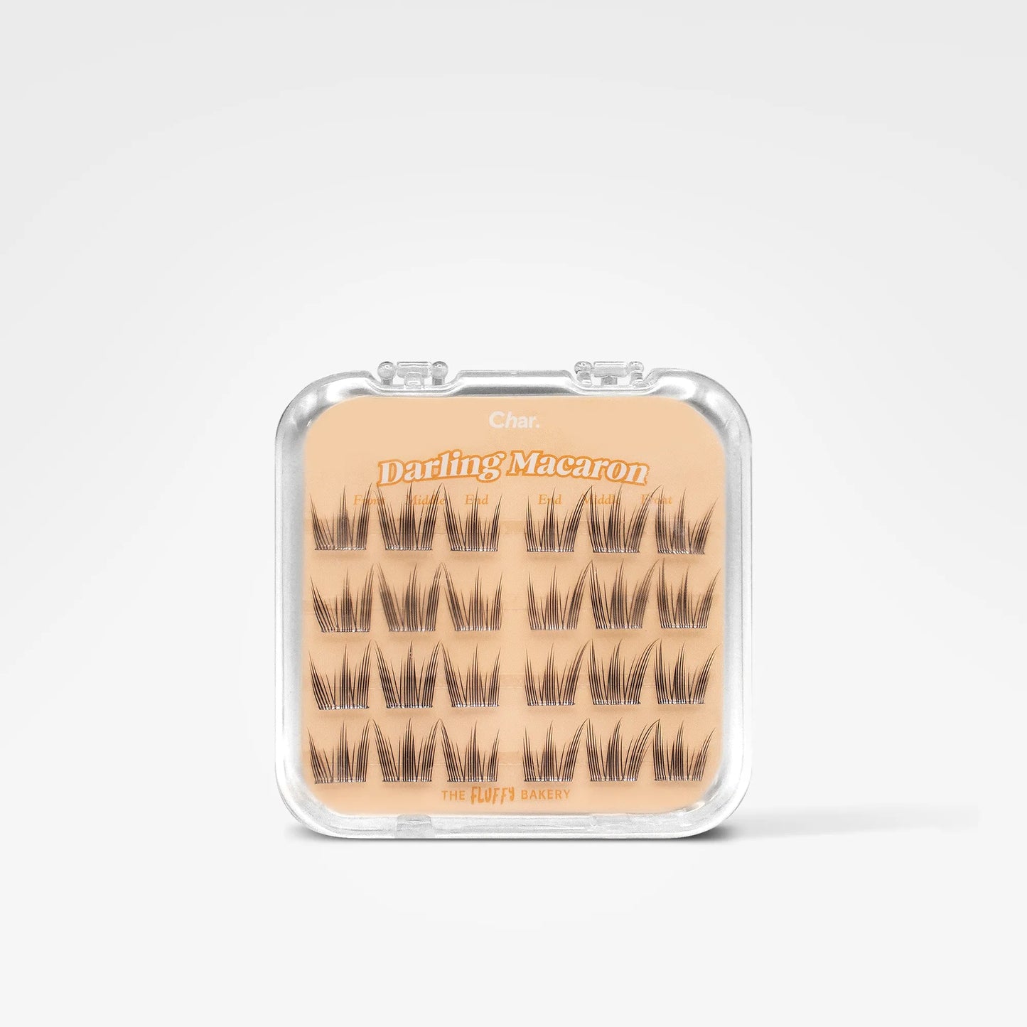 A clear plastic clamshell case containing 18 pairs of false eyelashes on a beige card labeled 'Daring Macaron' by The Bitter Batch, set against a clean white background.