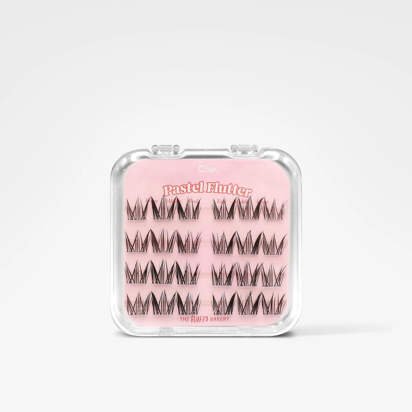 A clear plastic clamshell case containing three rows of black eyelash clusters on a pink backing card. The card reads 'Pastel Flute' and 'The Hair's Axxessy'.