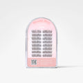 A clear plastic arch-shaped package containing multiple pairs of black false eyelashes on a pink backing card. The card reads 'Dreamy Dove' and 'Char.