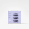 A clear plastic tray containing multiple rows of small black false eyelash clusters on a light lavender insert card with printed instructions and the brand name 'char'.